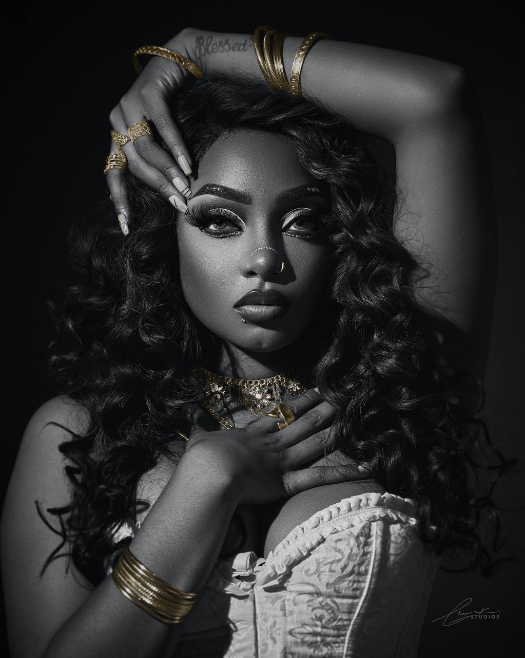 Black-and-white beauty portrait with dramatic styling and jewelry